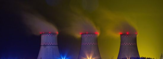 Thermal power plant. Cooling towers, steam from pipes.